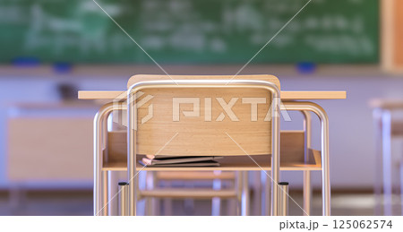 School desk and chair with books underneath facing an empty classroom and chalkboard 125062574