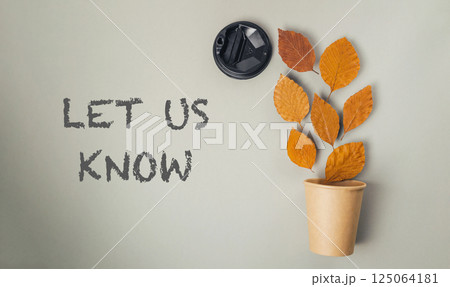 Leafy plant in a paper cup with the words Let us know written in black Leafy plant in a paper cup with the words Let us know written in black 125064181
