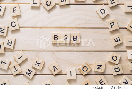 Wooden board with a bunch of wooden letters scattered around it Wooden board with a bunch of wooden letters scattered around it 125064192