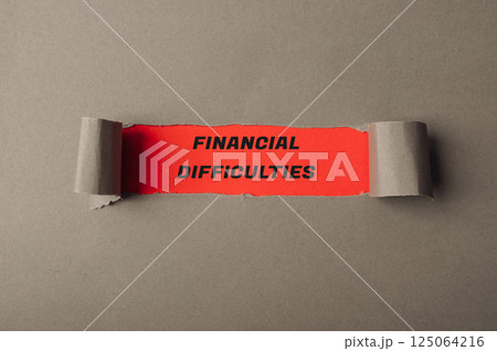 Torn piece of paper with the words financial difficulties written on it Torn piece of paper with the words financial difficulties written on it 125064216
