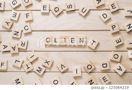 Jumble of wooden letters spell out the word client on a wooden surface 125064219