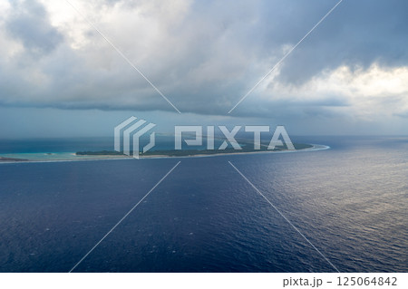 Aerial view of Tikehau atoll, French Polynesia, with cloudy sky and lagoon 125064842