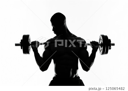 Man is lifting a weight in a gym 125065482