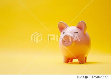 Piggy bank is sitting on a yellow background. 125065532