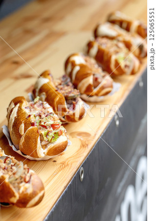 Gourmet Hotdogs on Wooden Serving Board Gourmet Hotdogs on Wooden Serving Board 125065551
