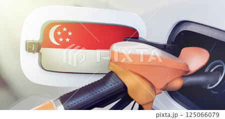 Singapore flag on the lid of the gas tank of a car at a gas station in close-up. High or low gasoline prices at Singaporean gas stations. Gasoline prices are rising due to a shortage of diesel fuel Singapore flag on the lid of the gas tank of a car at a gas station in close-up. High or low gasoline prices at Singaporean gas stations. Gasoline prices are rising due to a shortage of diesel fuel 125066079