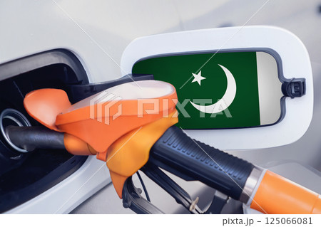 The flag of Pakistan on the lid of the gas tank of a car at a gas station in close-up. High or low gasoline prices at Pakistani gas stations. Gasoline prices are rising in Pakistan due to a shortage The flag of Pakistan on the lid of the gas tank of a car at a gas station in close-up. High or low gasoline prices at Pakistani gas stations. Gasoline prices are rising in Pakistan due to a shortage 125066081