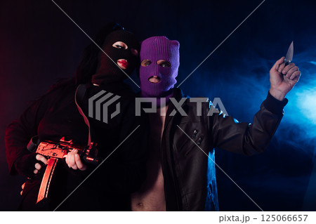 Man And Woman Wearing Mask With Gun 125066657