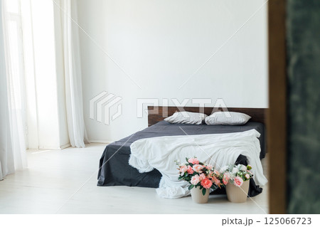Interior of a room with a sleeping bed and a basket of flowers 125066723