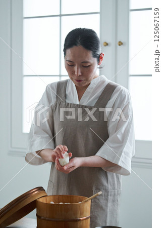 おにぎりを握る女性 125067159