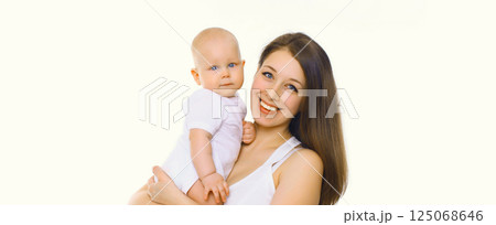 Happy cheerful smiling mother holding baby, joyful young mom and little child on white background 125068646