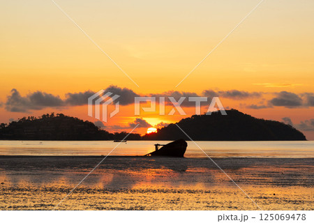 Beautiful sunrise at Saphanhin public beach, Phuket, Thailand. 125069478