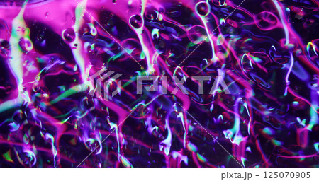 Neon glow. Defocused colorful splash. Purple gleaming transparent fragments lens flare motion on blurred bokeh light modern background. Neon glow. Defocused colorful splash. Purple gleaming transparent fragments lens flare motion on blurred bokeh light modern background. 125070905