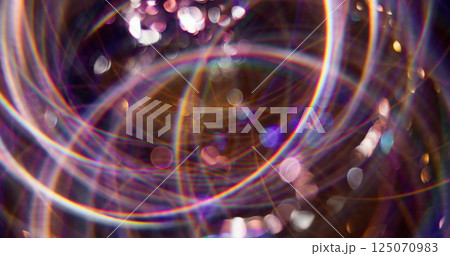 Magical disco. Defocused festive decoration. Multicolor shining attractive particles lens flare motion on blurred bokeh light background. 125070983