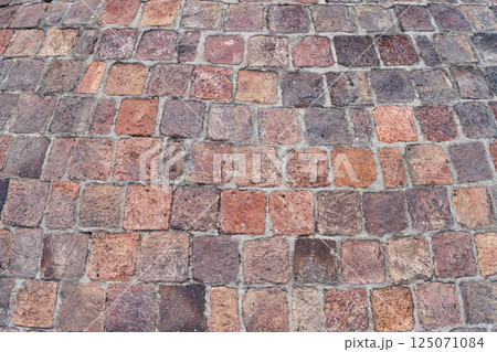 Old brick paving stones on the street background Old brick paving stones on the street background 125071084