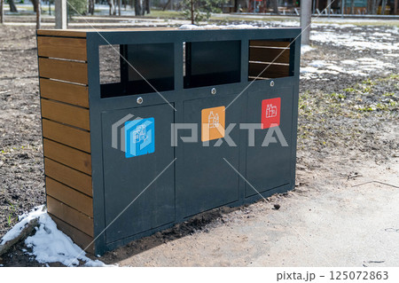 Modern recycling bins promoting waste sorting in public park Modern recycling bins promoting waste sorting in public park 125072863