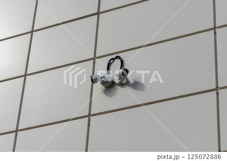 Security cameras observing building facade ensuring safety and surveillance 125072886