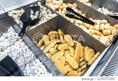 Frozen semi-finished products in a grocery store. A good natural product for fast cooking delicious food Frozen semi-finished products in a grocery store. A good natural product for fast cooking delicious food 125075161