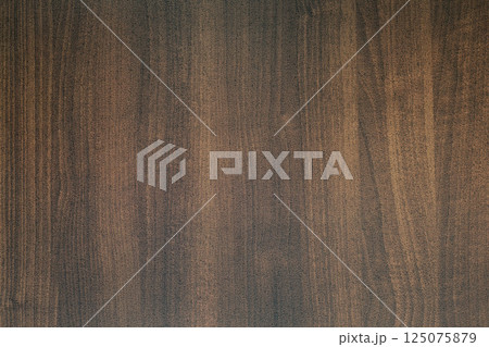 Dark brown wood grain texture background showing growth rings Dark brown wood grain texture background showing growth rings 125075879