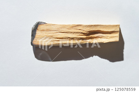 Piece of palo santo wood with shadow on white background abstract composition 125078559