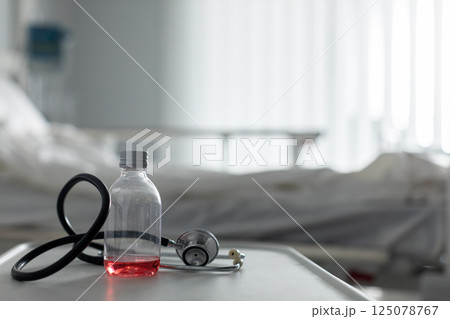 A vial and stethoscope are essential tools for healthcare professionals in a hospital A vial and stethoscope are essential tools for healthcare professionals in a hospital 125078767