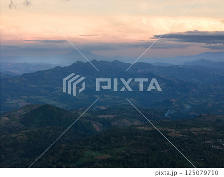 Sunset over mountains and distant hills in serene, scenic view 125079710