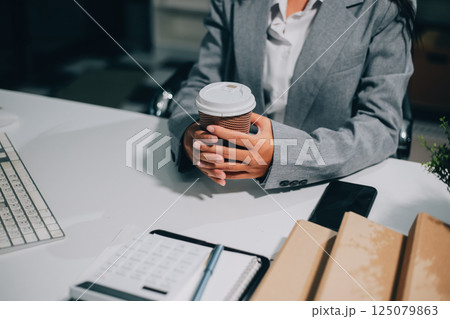 Portrait of Asian young female working on laptop at office 125079863