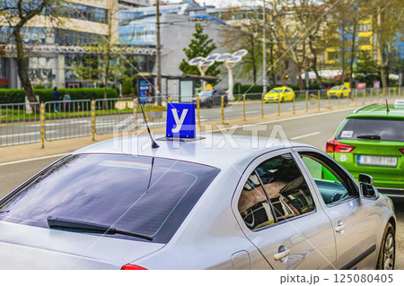 Car with Driving school blue sign on roof used in Bulgaria. Sign training vehicle. Learning driving skills in driving school. Concept of driver license, traffic rules Car with Driving school blue sign on roof used in Bulgaria. Sign training vehicle. Learning driving skills in driving school. Concept of driver license, traffic rules 125080405