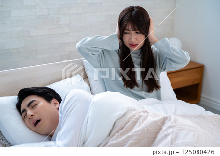 いびきに悩まされる若い女性 いびきに悩まされる若い女性 125080426