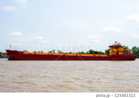 Old weathered general cargo ship on Mekong river, Vietnam 125081322