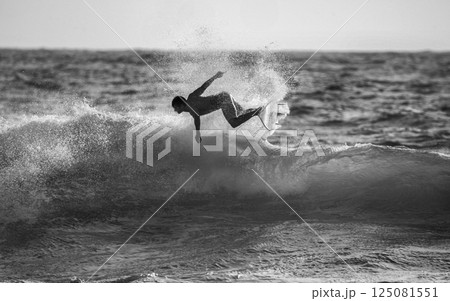 Fantastic Surfer Water Splash and Surfer Jump  He Seemed to be Hanging in the Air (Unrecognizable Person). 125081551