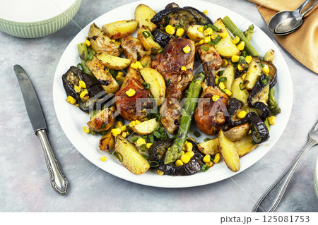 Roast chicken thigh garnished with vegetables. Roast chicken thigh garnished with vegetables. 125081753