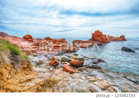 Impressive sunset view of Red Rocks (is Scoglius Arrubius) on Cea beach. 125082103