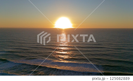 Golden Sunset Over Calm Ocean Captured by Drone Golden Sunset Over Calm Ocean Captured by Drone 125082889