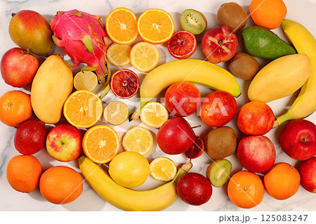 Summer tropical fruits on marble table, source of vitamin C, banner for shop, healthy vegan products for healthy lifestyle, detox diet and weight loss concept, shop advertisement. 125083247