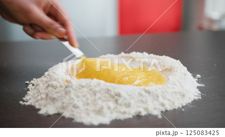 Mix Eggs And Flour For The Typical Sweet Food 125083425