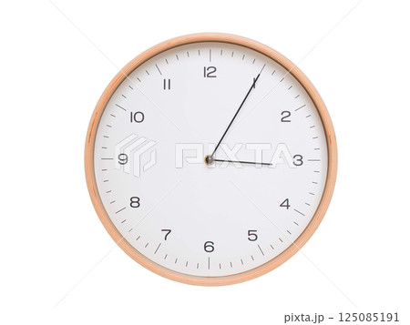 Minimal wall clock with light wood frame and white face displaying 03:05 or 15:05. Perfect for clean, modern concepts about time and scheduling. 125085191
