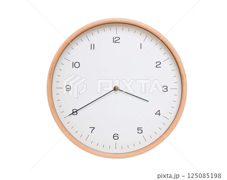 Minimal wall clock with light wood frame and white face displaying 03:40 or 15:40. Perfect for clean, modern concepts about time and scheduling. 125085198