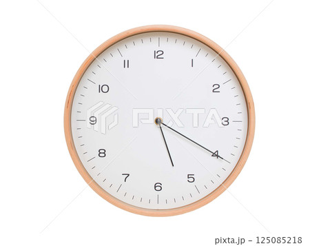 Minimal wall clock with light wood frame and white face displaying 05:20 or 17:20. Perfect for clean, modern concepts about time and scheduling. 125085218