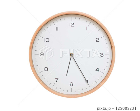 Minimal wall clock with light wood frame and white face displaying 06:25 or 18:25. Perfect for clean, modern concepts about time and scheduling. 125085231