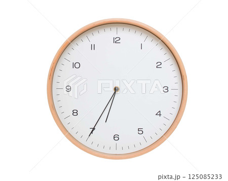Minimal wall clock with light wood frame and white face displaying 06:35 or 18:35. Perfect for clean, modern concepts about time and scheduling. 125085233