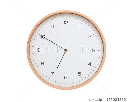Minimal wall clock with light wood frame and white face displaying 06:50 or 18:50. Perfect for clean, modern concepts about time and scheduling. 125085236