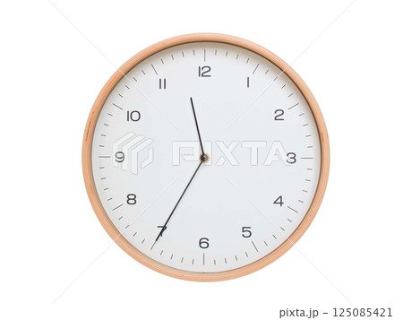 Minimal wall clock with light wood frame and white face displaying 11:35 or 23:35. Perfect for clean, modern concepts about time and scheduling. Minimal wall clock with light wood frame and white face displaying 11:35 or 23:35. Perfect for clean, modern concepts about time and scheduling. 125085421