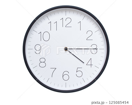 Simple wall clock with black frame and white face displaying 04:15 or 16:15. Ideal for time, schedule, and punctuality themes. 125085454