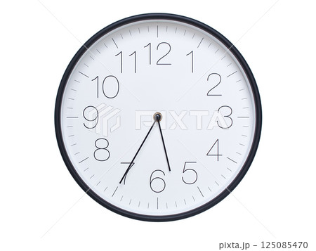 Simple wall clock with black frame and white face displaying 05:35 or 17:35. Ideal for time, schedule, and punctuality themes. 125085470