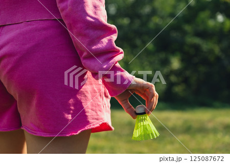 Unrecognizable woman playing with Wooden badminton rackets and shuttlecocks soft focus concept. Copy space Summer outdoor activities. Staycation leisure 125087672