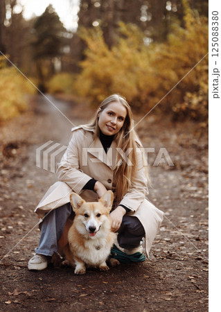 Woman with Corgi in Autumn Park Woman with Corgi in Autumn Park 125088380