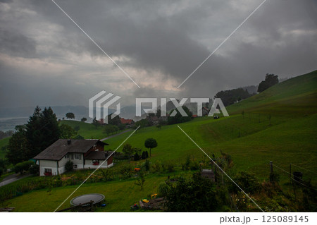 Cloudy morning over the rolling hills near Bodensee in Switzerland, creating a moody landscape 125089145