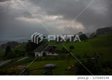 Captivating storm clouds hover over lush green hills near Lake Bodensee in Switzerland 125089146