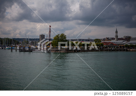 Exploring the picturesque beauty of Bodensees harbor under a moody sky Exploring the picturesque beauty of Bodensees harbor under a moody sky 125089157